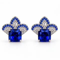 Pair of blue cushion-centre stud earrings with white and blue stones forming a three-lobed crest on a white background.