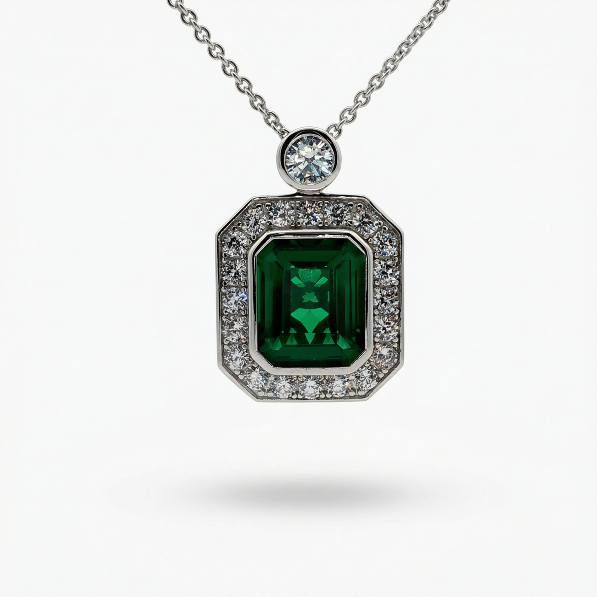 Emerald and Diamond Charm Necklace in White Gold Plated Silver