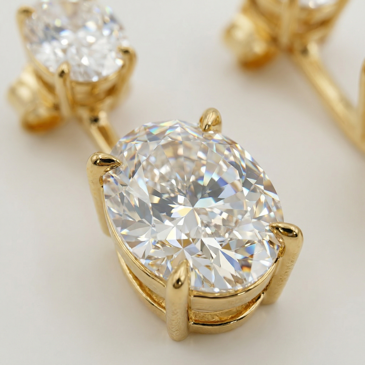 Air Drop Earrings with White Oval Stone – on Yellow Gold