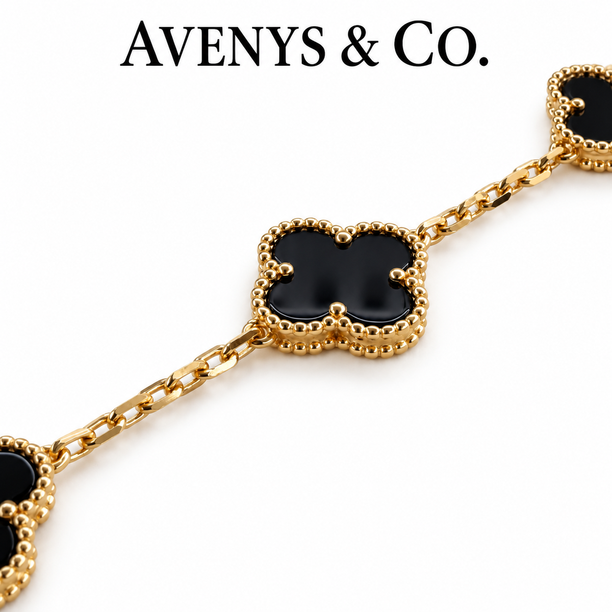 Black motif, beaded yellow gold border and faceted chain detail