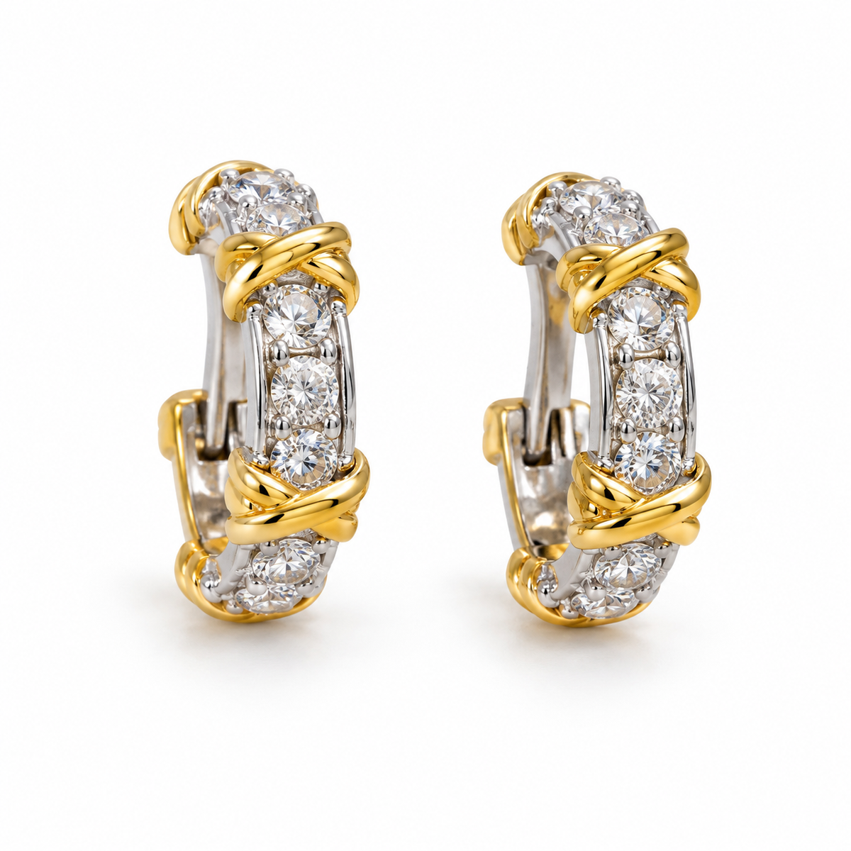 Slim white-stone hoop earrings in silver tone with yellow-gold crossed wrap accents on a white background.
